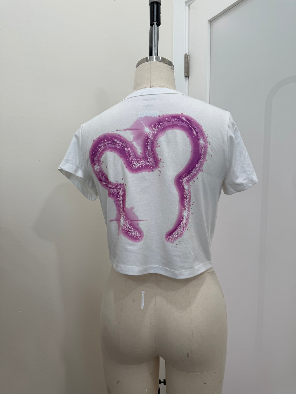 YOUR WATCHING DC PINK BABY TEE