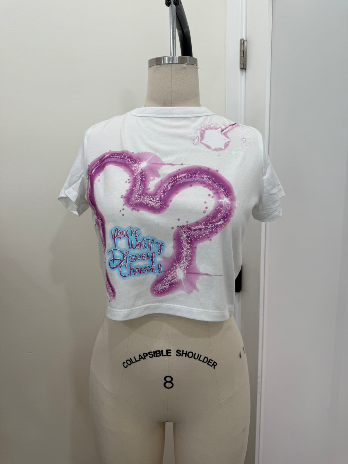 YOUR WATCHING DC PINK BABY TEE
