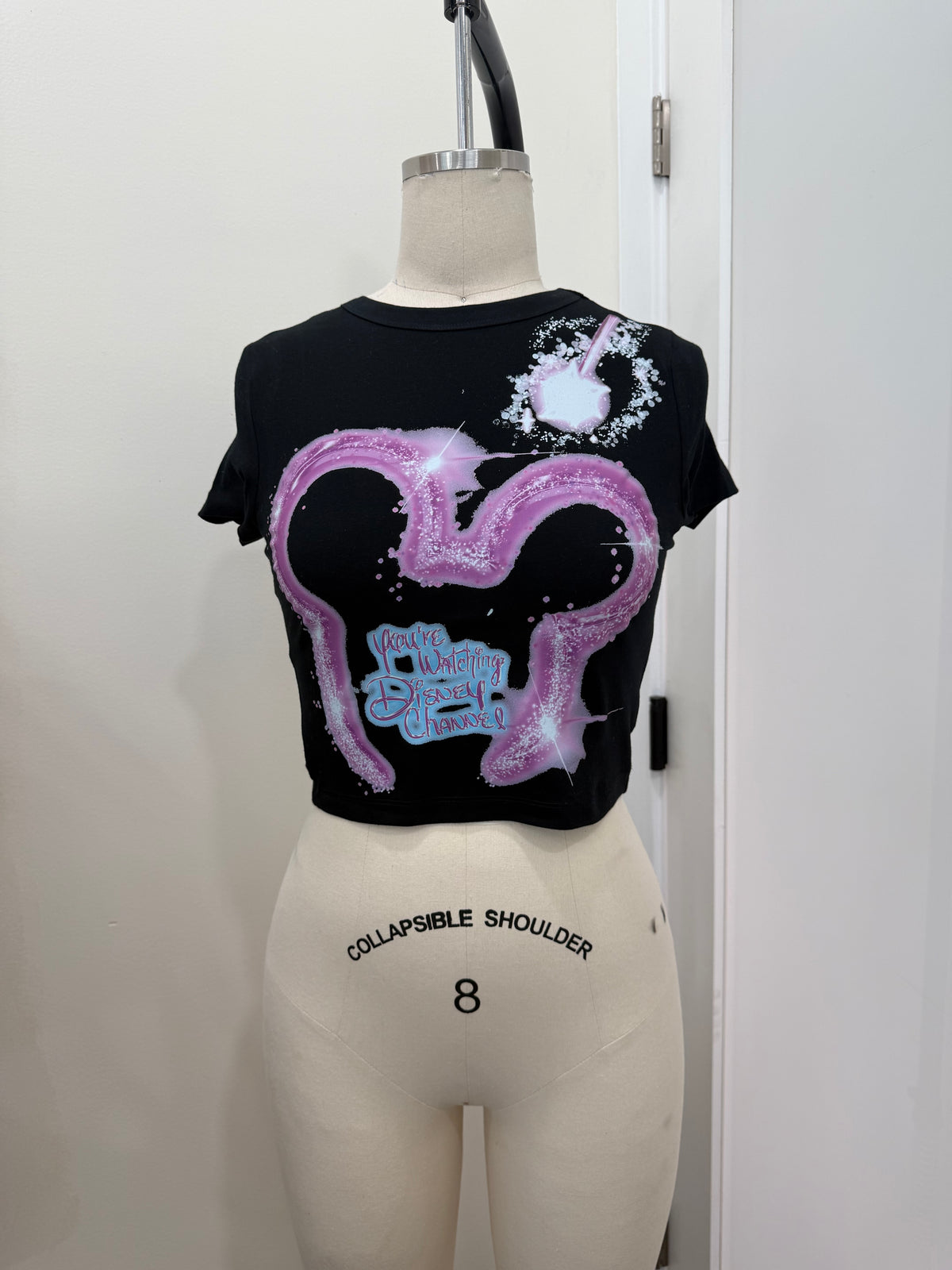 YOUR WATCHING DC PINK BABY TEE