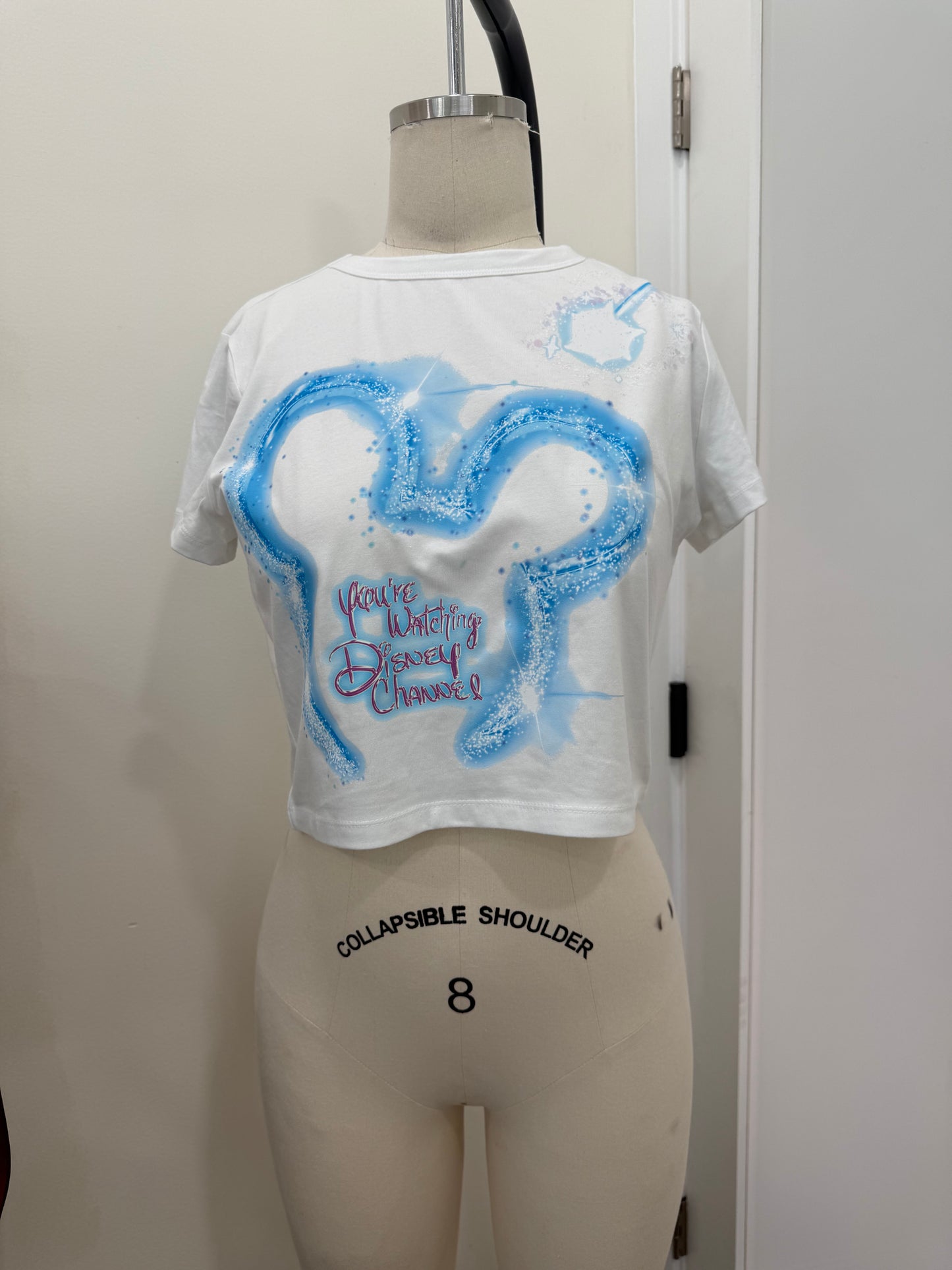 YOUR WATCHING DC BLUE BABY TEE